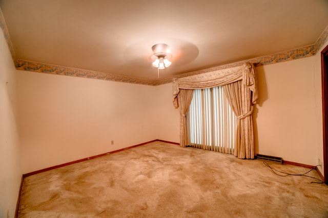 spare room featuring carpet and ceiling fan