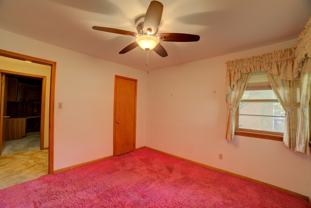 spare room featuring light colored carpet and ceiling fan