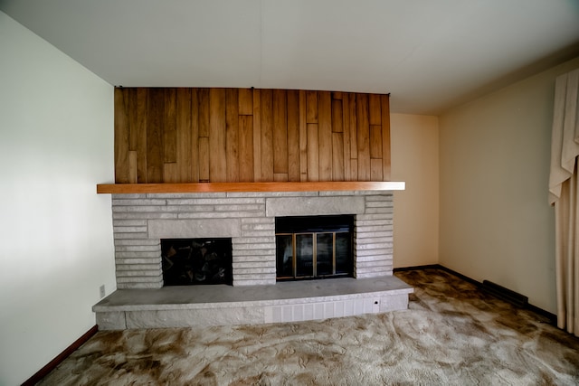 unfurnished living room featuring a fireplace and carpet floors