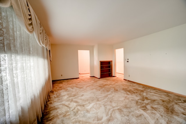 unfurnished bedroom featuring light carpet