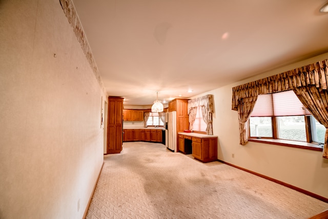 interior space with white fridge and light colored carpet