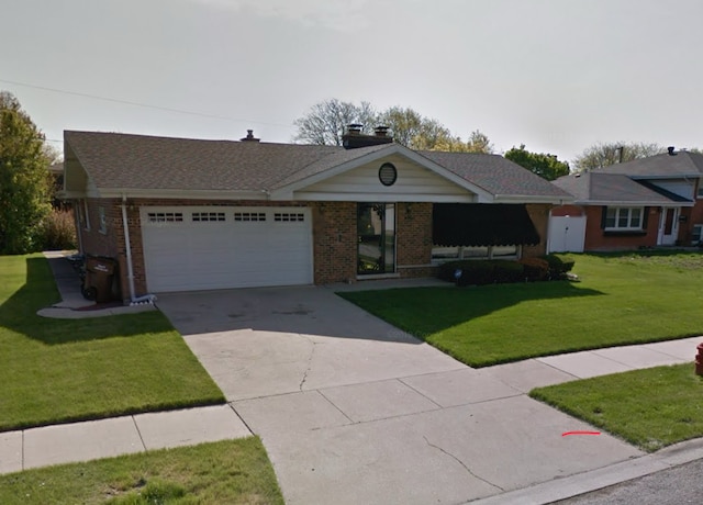 ranch-style home with a garage and a front yard