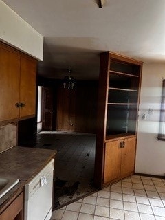 kitchen featuring light tile patterned flooring and white dishwasher