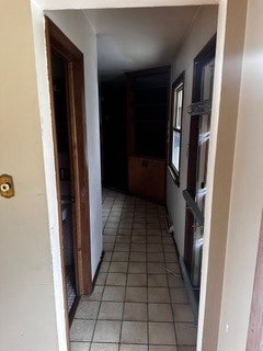 hall featuring light tile patterned floors