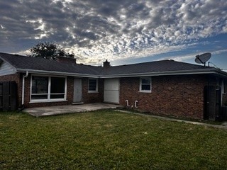 rear view of property with a patio and a yard