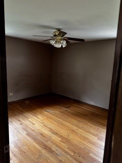 spare room with ceiling fan and hardwood / wood-style flooring