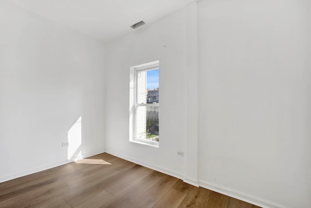 empty room with hardwood / wood-style floors