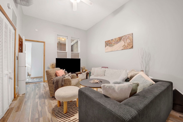 living room with ceiling fan and light hardwood / wood-style flooring