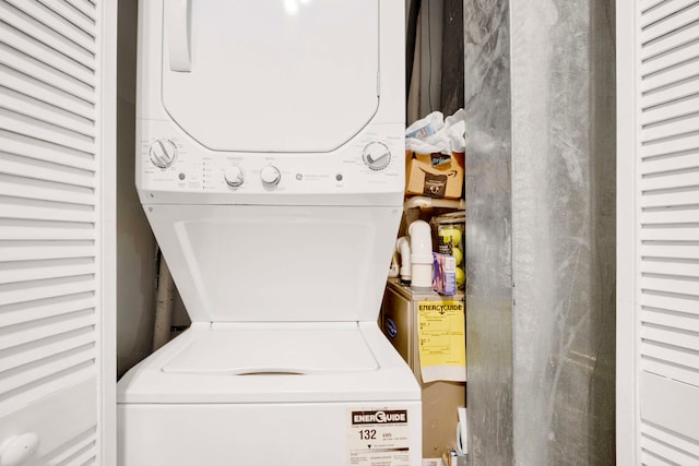 clothes washing area featuring stacked washer and clothes dryer