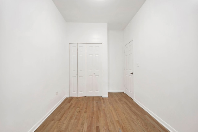 unfurnished bedroom featuring a closet and light hardwood / wood-style flooring