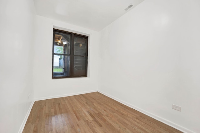 empty room with light hardwood / wood-style flooring