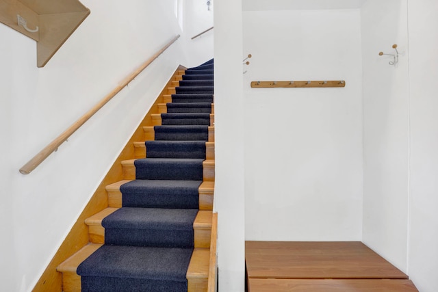 stairs featuring hardwood / wood-style floors