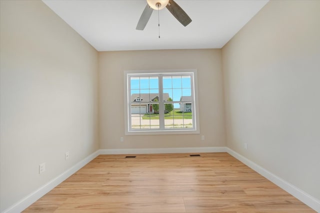 704 Justice St, Tuscola, IL 61953 - empty room with ceiling fan, light wood-style flooring, and baseboards