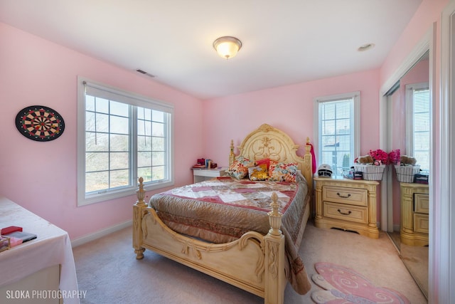 bedroom featuring light carpet