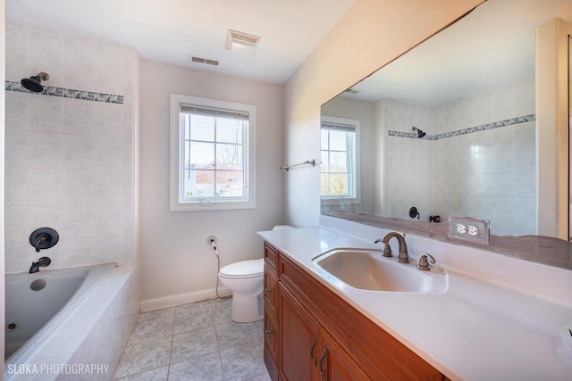 full bathroom with tiled shower / bath combo, vanity, tile patterned flooring, and toilet