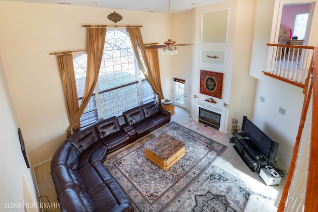 living room featuring a towering ceiling and carpet floors