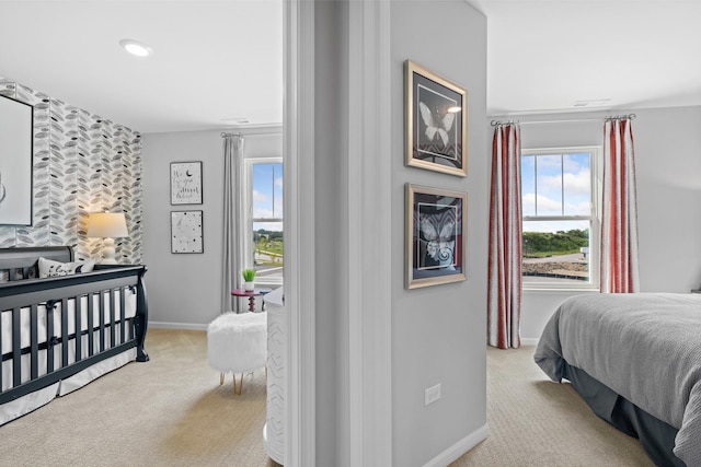 bedroom with light carpet and baseboards