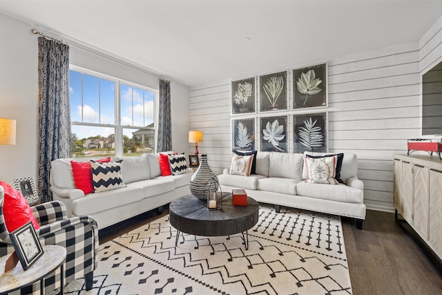 living room with hardwood / wood-style flooring and wooden walls