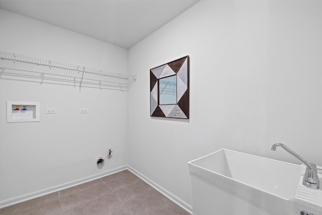 laundry area with laundry area, baseboards, hookup for a gas dryer, hookup for a washing machine, and a sink