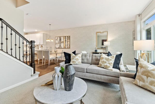 living room featuring an inviting chandelier and hardwood / wood-style floors