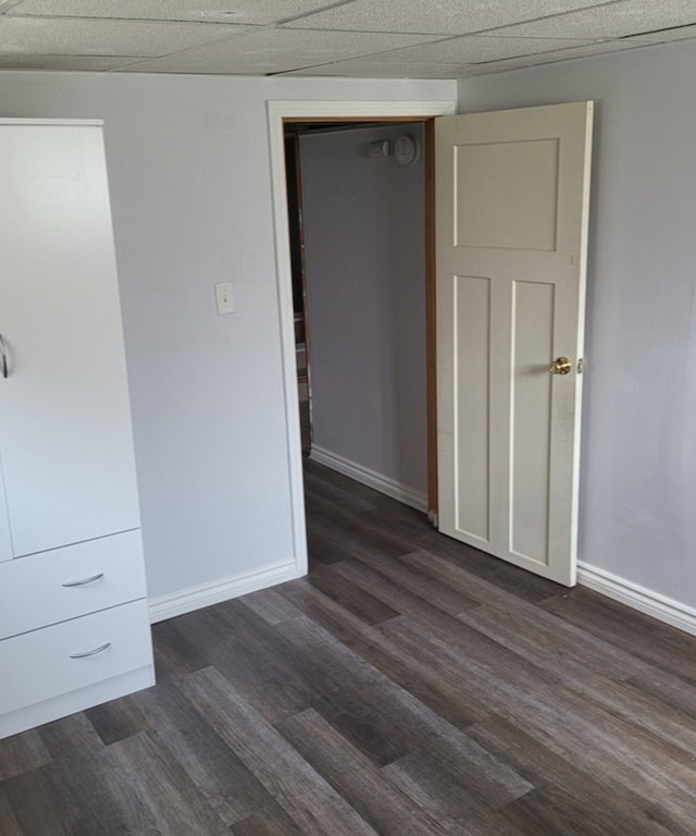 basement with light tile patterned flooring and wood walls