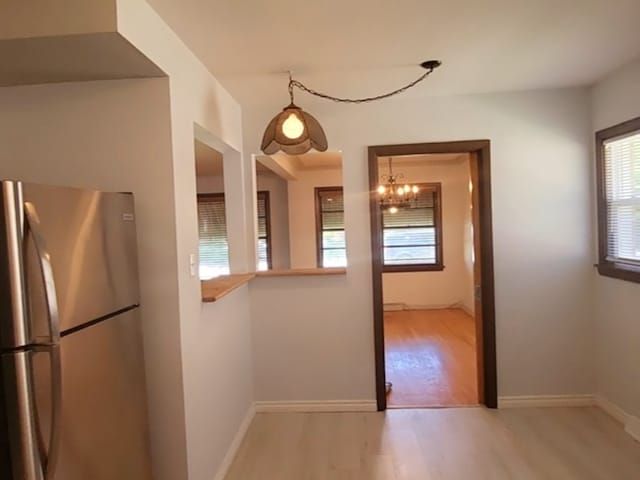 kitchen featuring appliances with stainless steel finishes, light wood-type flooring, decorative backsplash, and sink