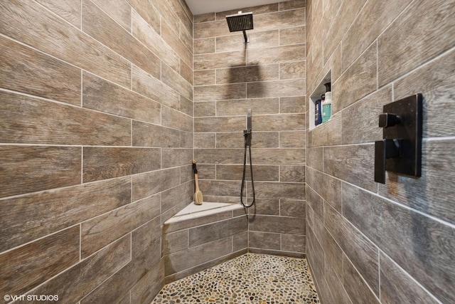 bathroom with a tile shower