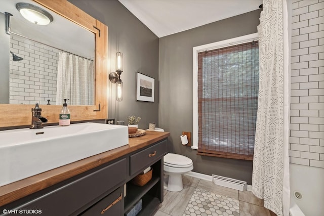 full bathroom featuring toilet, vanity, tile patterned floors, and shower / bath combo with shower curtain