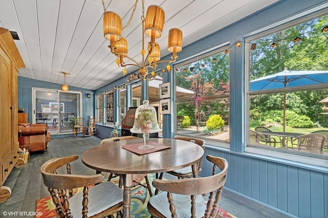 sunroom featuring plenty of natural light, wooden ceiling, and a notable chandelier