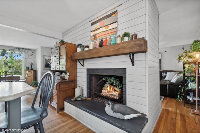 living room with hardwood / wood-style flooring and a fireplace