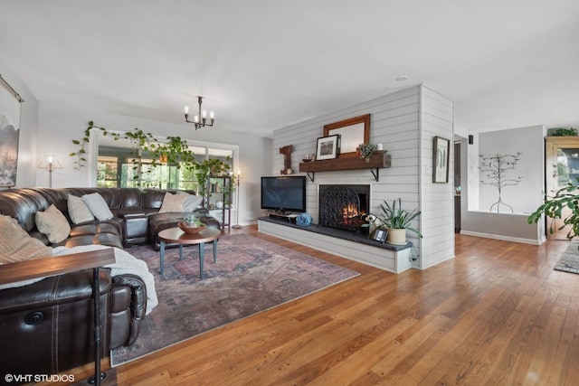 living room featuring hardwood / wood-style floors and an inviting chandelier