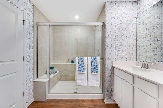 bathroom with vanity, hardwood / wood-style floors, and an enclosed shower