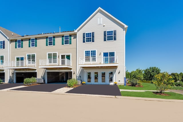 view of front of home featuring a balcony and a garage