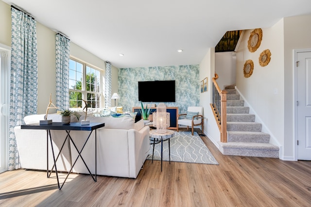 living room featuring wood-type flooring and a fireplace