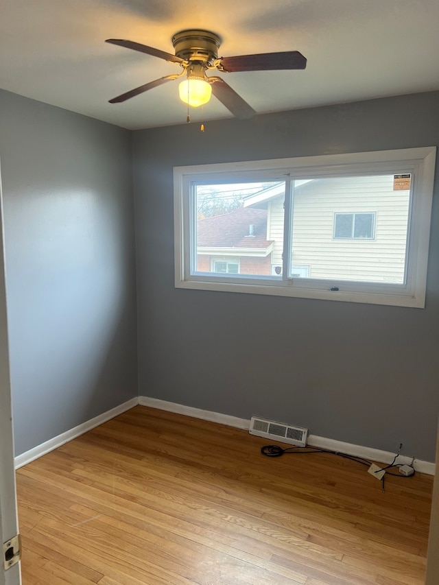 spare room with light hardwood / wood-style floors and ceiling fan