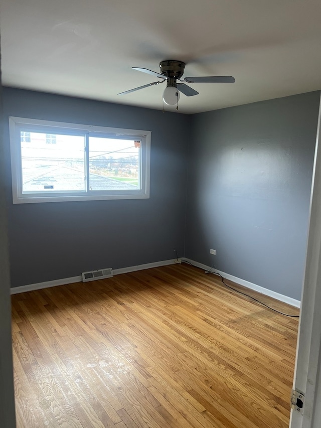 empty room with light hardwood / wood-style flooring, ceiling fan, and a healthy amount of sunlight