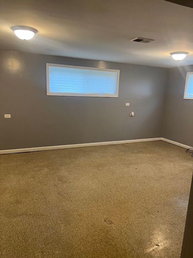 spare room featuring carpet flooring and plenty of natural light