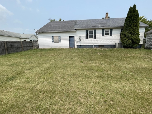 rear view of house with a yard