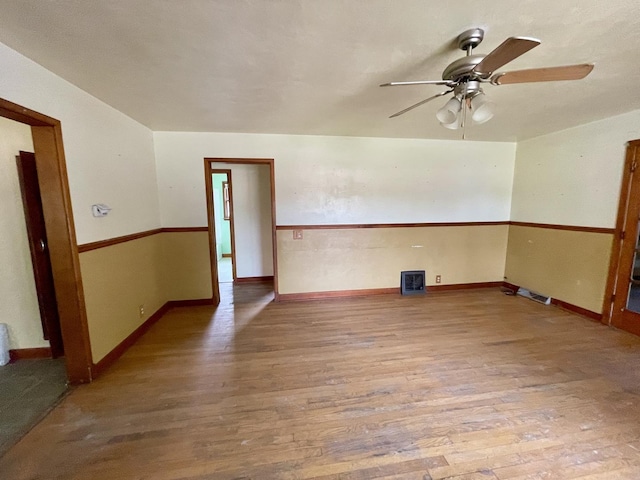 spare room with hardwood / wood-style flooring and ceiling fan