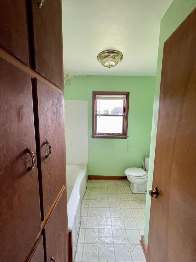 bathroom featuring a bathtub and toilet