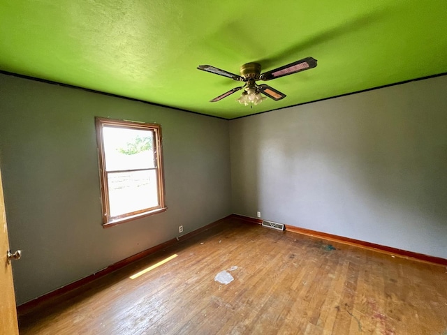 spare room with ceiling fan and light hardwood / wood-style floors