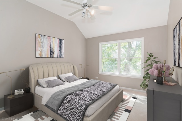 bedroom with ceiling fan, vaulted ceiling, and light carpet