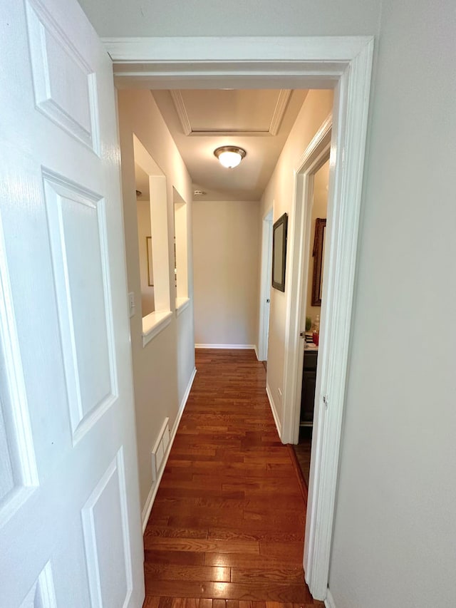 hall with crown molding and dark hardwood / wood-style flooring