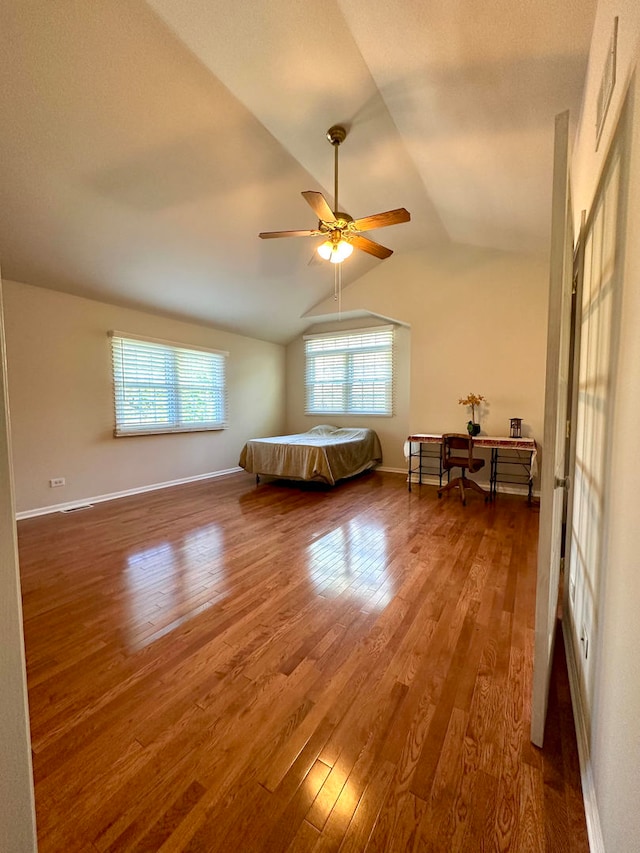 unfurnished room featuring wood-type flooring, lofted ceiling, and ceiling fan