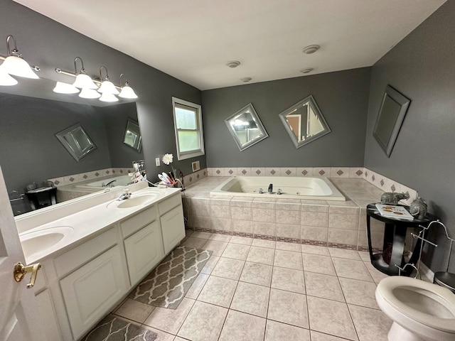 bathroom with tile patterned flooring, tiled bath, vanity, and toilet