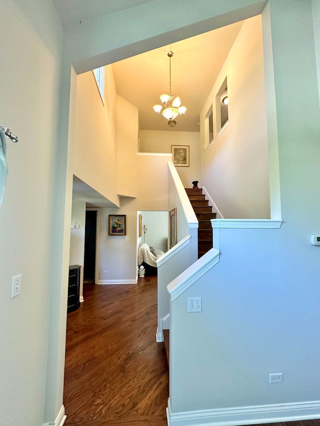 entrance foyer with dark wood-type flooring and a chandelier