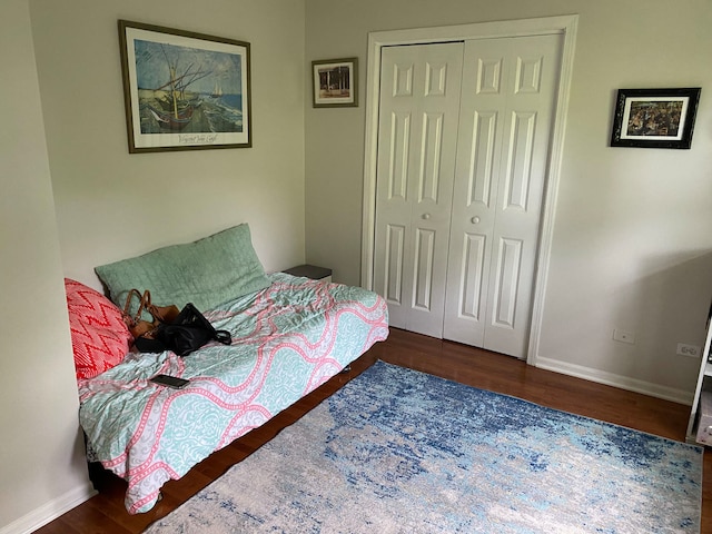 bedroom featuring a closet and dark hardwood / wood-style floors