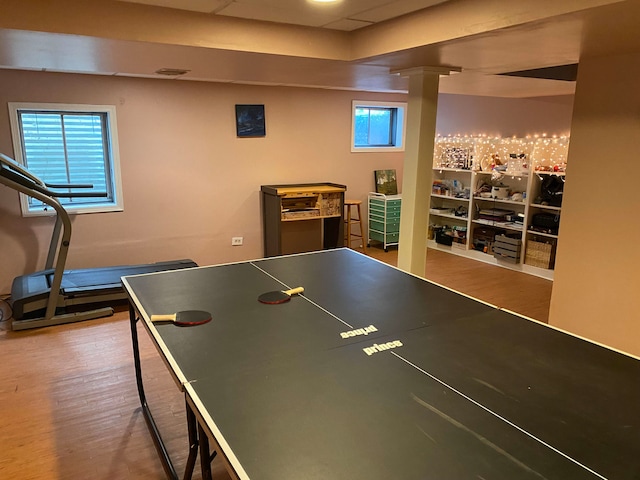 playroom featuring wood-type flooring and decorative columns