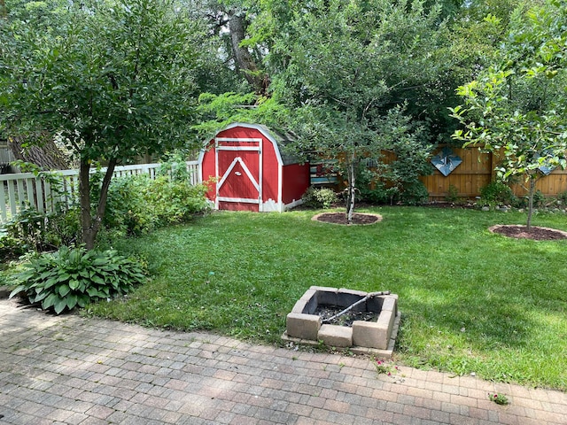 view of yard with a storage unit and a patio area