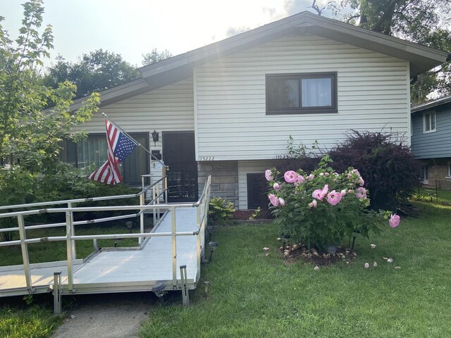 rear view of property with a lawn